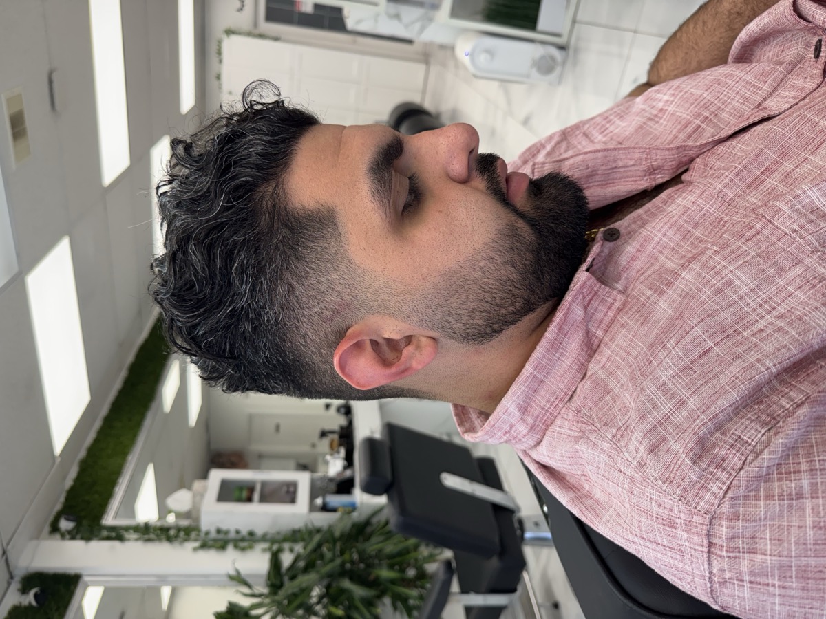 Curly top with fade and beard